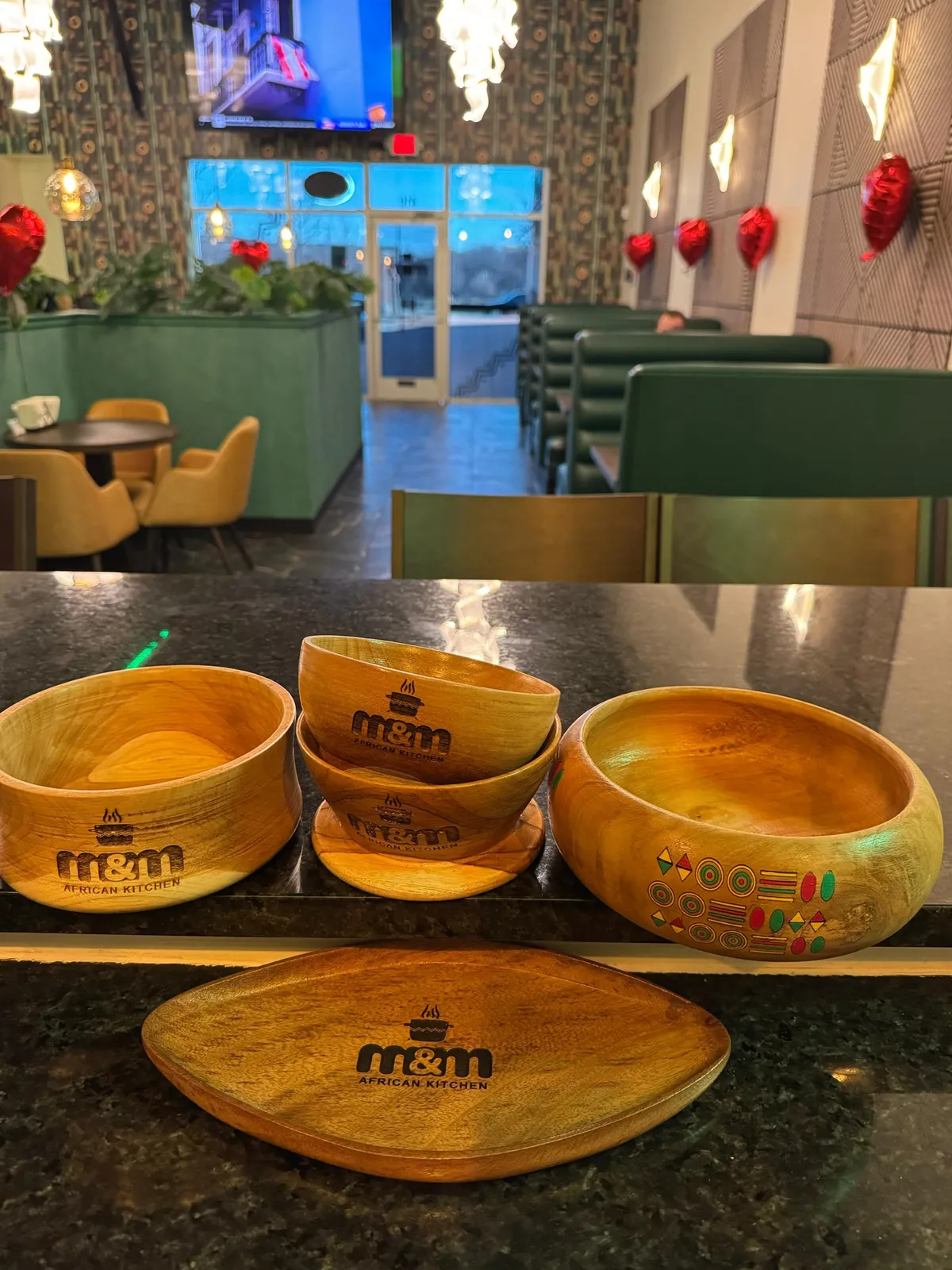 M&M African Kitchen dining room with branded serving bowls and green booths